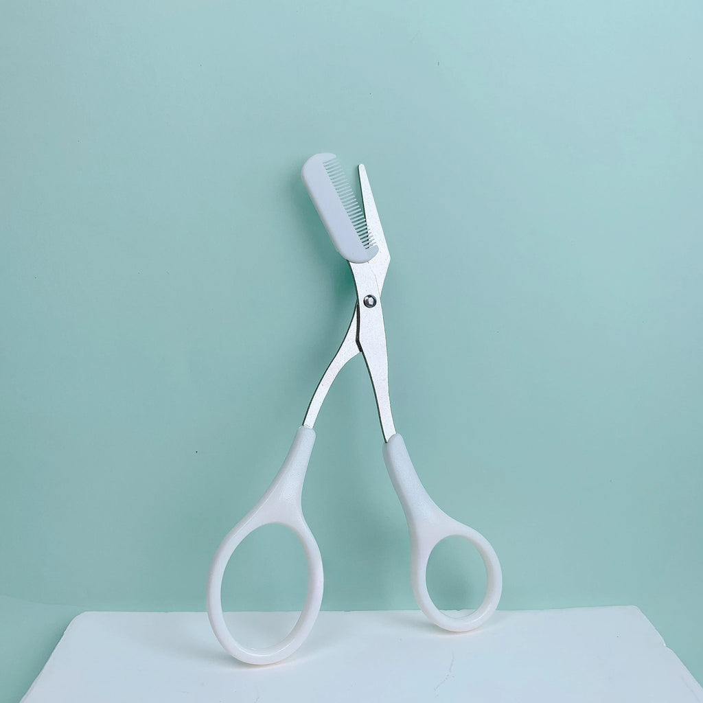 Eyebrow trimming scissors with built-in comb.