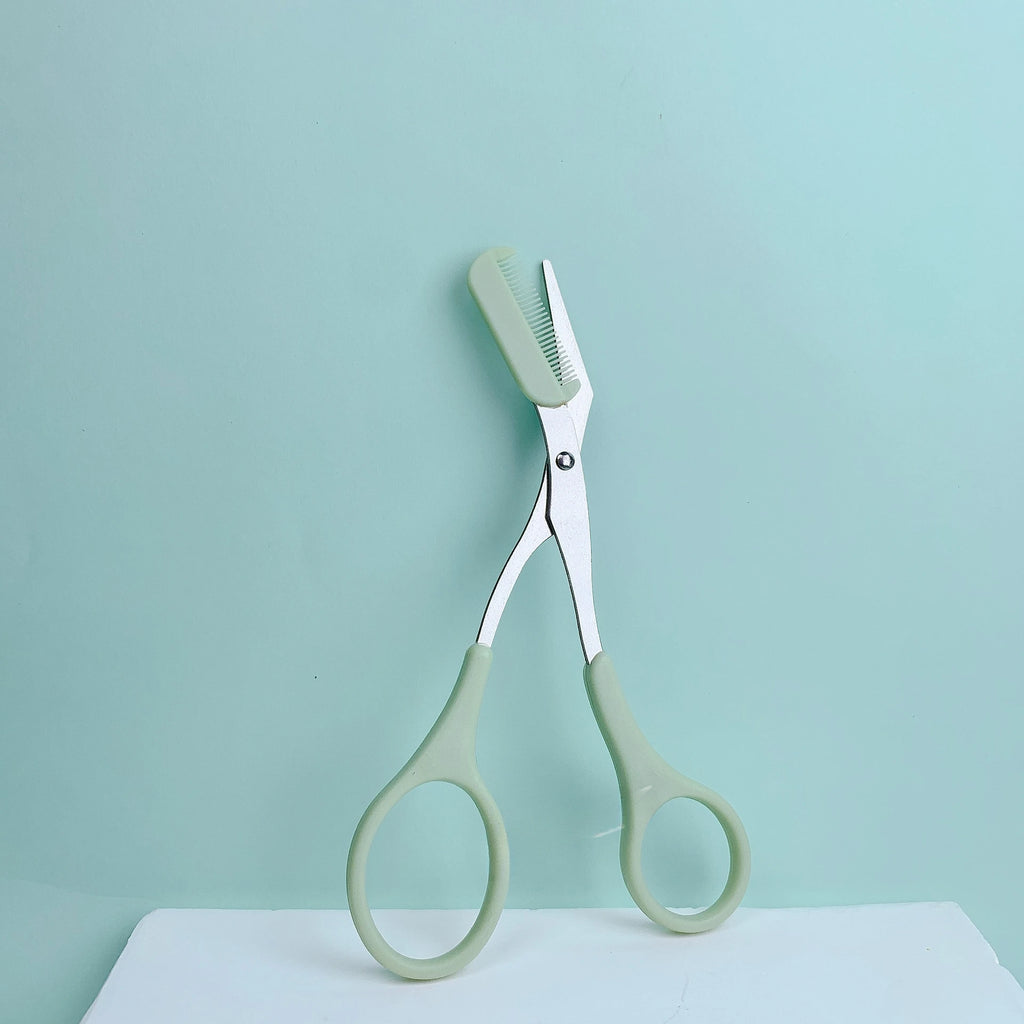 Eyebrow trimming scissors with built-in comb.